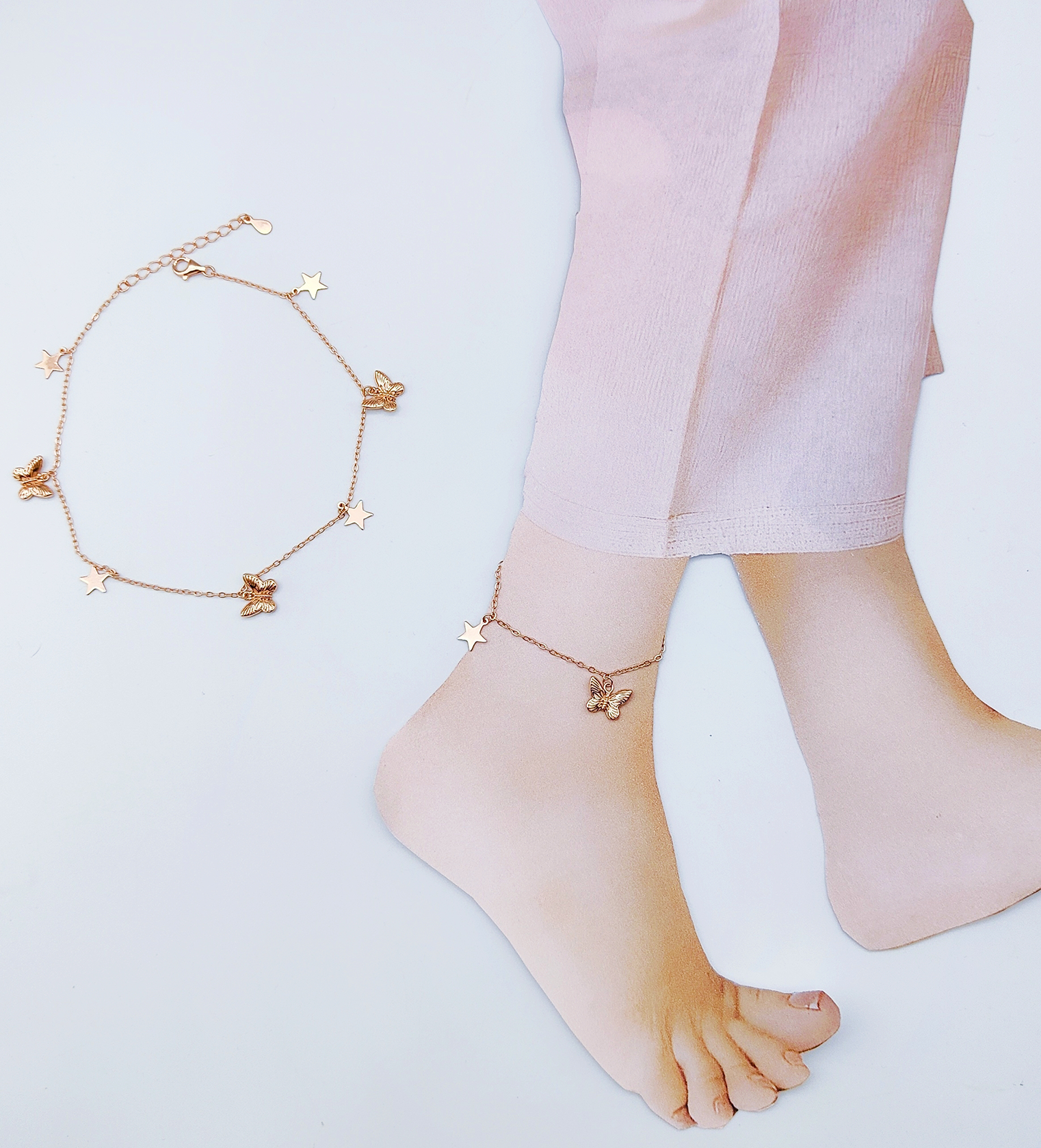 Minimalist 925 silver butterfly charm anklet on woman's ankle white background — Ross Jewells daily wear jewellery Minimalist 925 silver butterfly charm anklet on woman's ankle white background — Ross Jewells daily wear jewellery