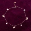 Silver 925 butterfly and star charm anklet worn on ankle dark background — tarnish resistant daily wear Ross Jewells Silver 925 butterfly and star charm anklet worn on ankle dark background — tarnish resistant daily wear Ross Jewells