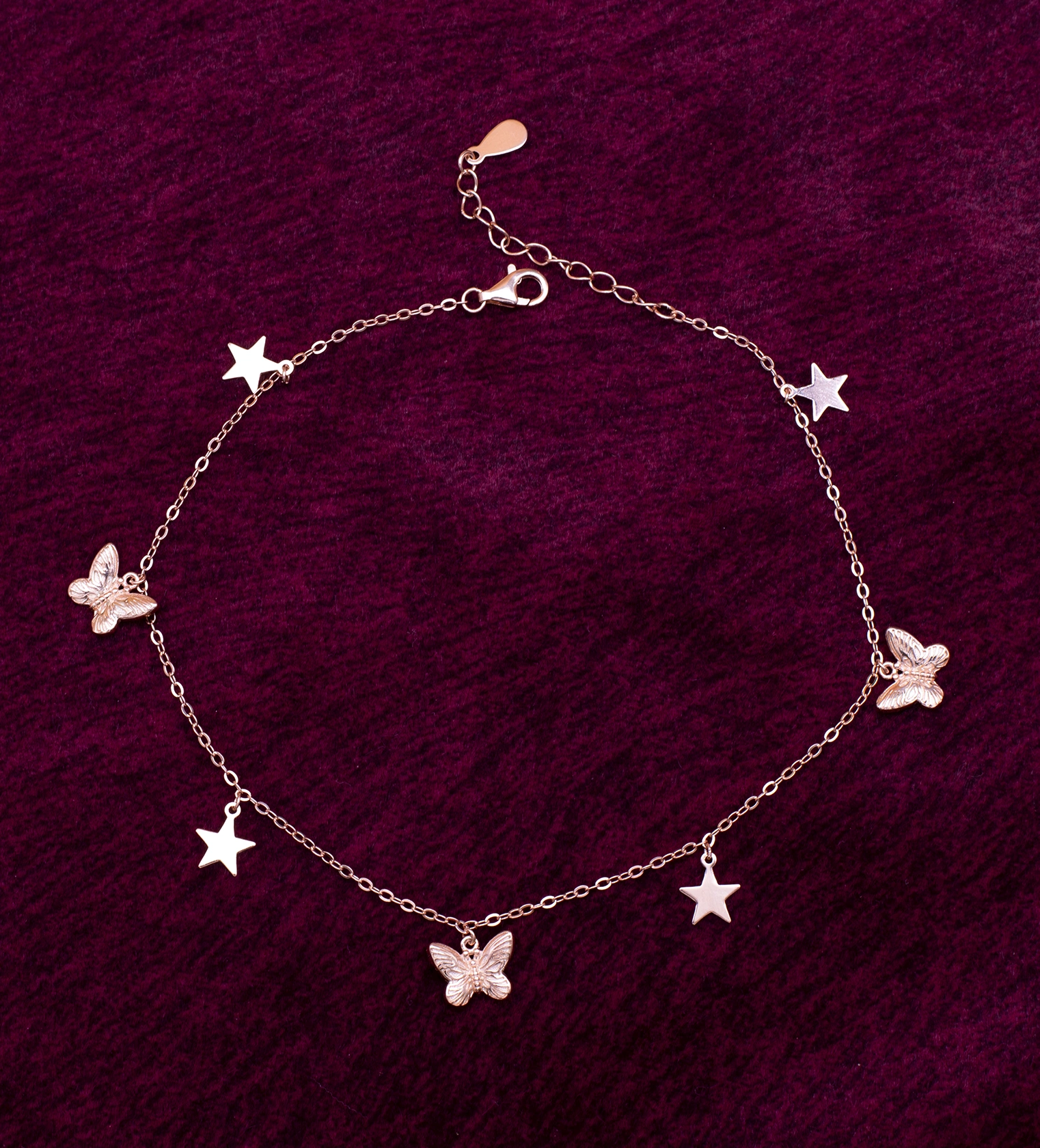 Silver 925 butterfly and star charm anklet worn on ankle dark background — tarnish resistant daily wear Ross Jewells Silver 925 butterfly and star charm anklet worn on ankle dark background — tarnish resistant daily wear Ross Jewells